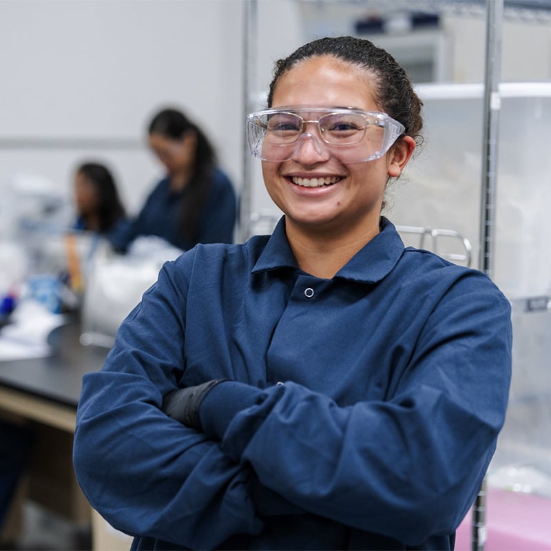 Smiling employee standing in FDA-registered fill-finish site.