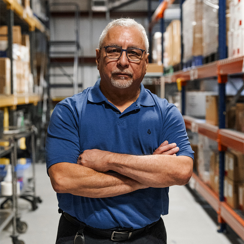 Supply chain coordinator standing in warehouse. 