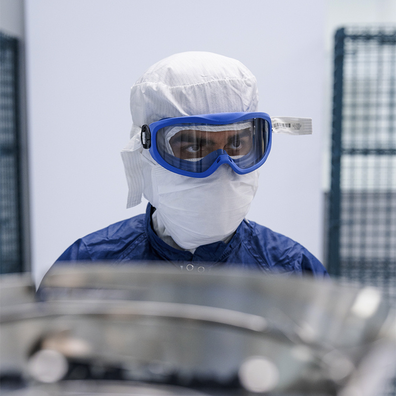 American Injectables employee in full PPE working on process engineering.