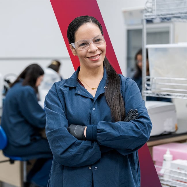 QC supervisor crossing their arms and smiling. 